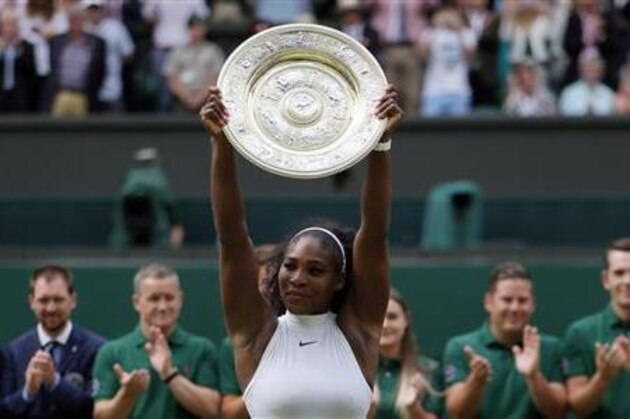Serena Williams of the U.S holds up her trophy after winning the women's singles final against Angelique Kerber of Germany on day thirteen of the Wimbledon Tennis Championships in London, Saturday, July 9, 2016. (AP Photo/Tim Ireland)
