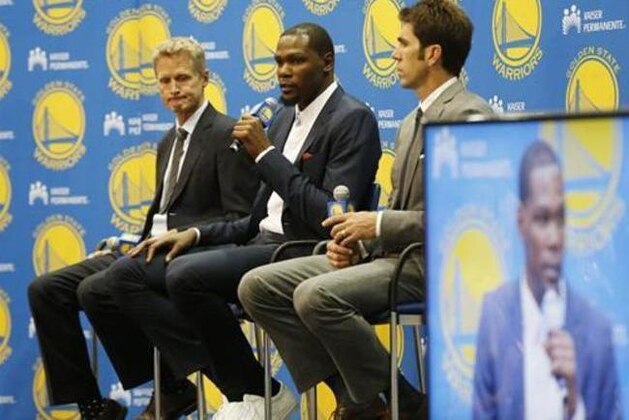 Golden State Warriors' Kevin Durant, center, speaks as coach Steve Kerr, left and general manager Bob Myers listen during a news conference at the NBA basketball team's practice facility, Thursday, July 7, 2016, in Oakland, Calif. (AP Photo/Beck Diefenbach)