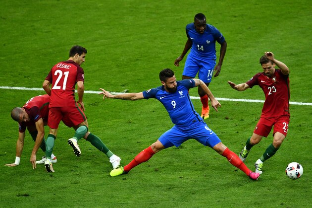 PARIS, FRANCE - JULY 10:  Olivier Giroud of France and Adrien Silva of Portugal compete for the ball during the UEFA EURO 2016 Final match between Portugal and France at Stade de France on July 10, 2016 in Paris, France.  (Photo by Dan Mullan/Getty Images)