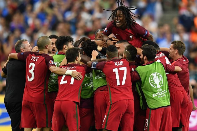 PARIS, FRANCE - JULY 10:  Renato Sanches (top) and Portugal players celebrate their team's first goal scored by Eder (obscured) during the UEFA EURO 2016 Final match between Portugal and France at Stade de France on July 10, 2016 in Paris, France.  (Photo by Laurence Griffiths/Getty Images)