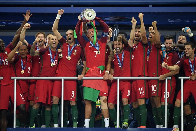 PARIS, FRANCE - JULY 10:  Cristiano Ronaldo of Portugal (c) lifts the European Championship trophy after his side win 1-0 against France during the UEFA EURO 2016 Final match between Portugal and France at Stade de France on July 10, 2016 in Paris, France.  (Photo by Matthias Hangst/Getty Images)