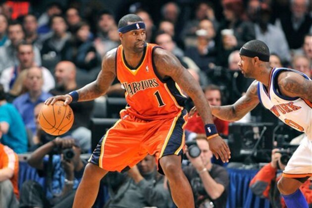 Golden State Warriors' Stephen Jackson (1) looks to pass around New York Knicks' Larry Hughes (0) during an NBA basketball game Friday, Nov.13, 2009, in New York. (AP Photo/Kathy Kmonicek)