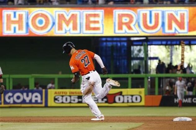 Miami Marlins' Giancarlo Stanton (27) rounds second base after hitting a two-run home run, also scoring Martin Prado, during the fifth inning of a baseball game against the Cincinnati Reds, Sunday, July 10, 2016, in Miami. (AP Photo/Wilfredo Lee)