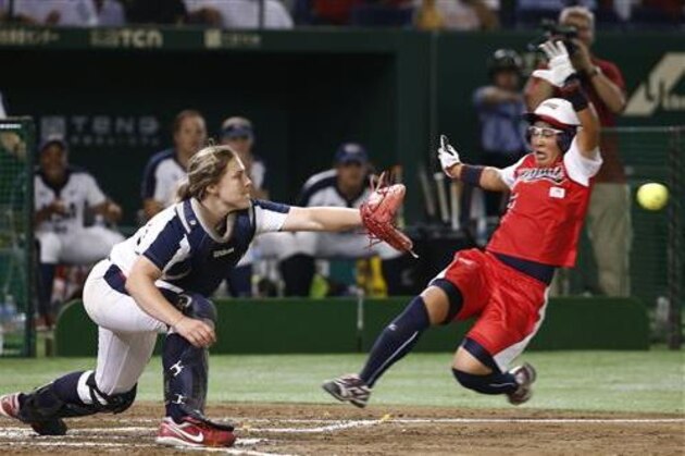 Japan's Yu Yamamoto slides into the home plate as United States catcher Amanda Chidester reaches for the ball in the fifth inning of their softball friendly game in Tokyo, Thursday, June 23, 2016. (AP Photo/Shizuo Kambayashi)