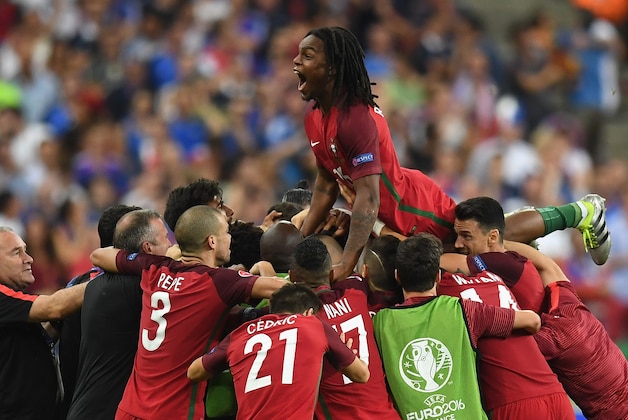 PARIS, FRANCE - JULY 10: Renato Sanches (top) and Portugal players celebrate their team's first goal during the UEFA EURO 2016 Final match between Portugal and France at Stade de France on July 10, 2016 in Paris, France.  (Photo by Laurence Griffiths/Getty Images)