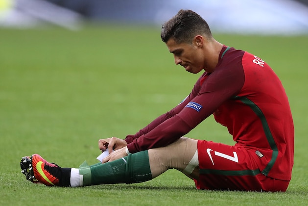 PARIS, FRANCE - JULY 10:  Cristiano Ronaldo of Portugal reacts to an injury during the UEFA Euro 2016 Final match between Portugal and France at Stade de France on July 10, 2016 in Paris, France.  (Photo by Matthew Ashton - AMA/Getty Images)