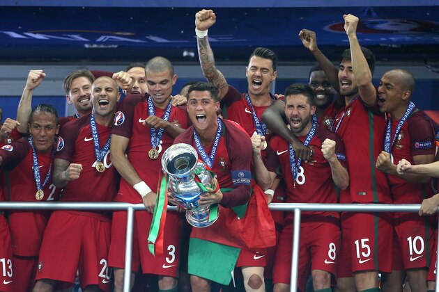 PARIS, FRANCE - JULY 10: Cristiano Ronaldo of Portugal celebrates the victory with teammates during the trophy ceremony following the UEFA Euro 2016 final match between Portugal and France at Stade de France on July 10, 2016 in Saint-Denis near Paris, France. (Photo by Jean Catuffe/Getty Images)