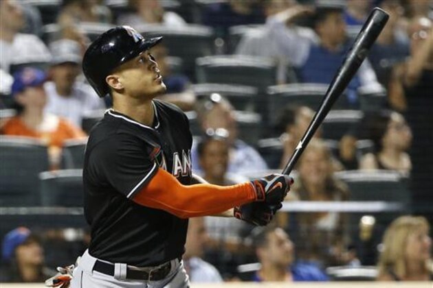 Miami Marlins Giancarlo Stanton watches his eighth-inning, three-run, home run in a baseball game against the New York Mets, Tuesday, July 5, 2016, in New York. It was Stanton's second home run of the game. (AP Photo/Kathy Willens)