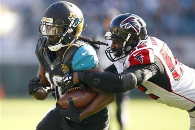 Jacksonville Jaguars running back Denard Robinson (16) tries to avoid Atlanta Falcons outside linebacker Justin Durant (52) during an NFL football game in Jacksonville, Fla., Sunday, Dec. 20, 2015. (Jeff Haynes/AP Images for Panini)