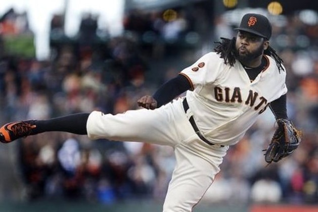 FILE - In this July 6, 2016, file photo, San Francisco Giants pitcher Johnny Cueto works against the Colorado Rockies in the first inning of a baseball game in San Francisco. Texas' Ian Desmond wasn’t the biggest name on the free agent market. But his big first half has helped the Rangers take a commanding lead in the AL West, and he’s been one of the most successful new acquisitions in baseball so far in 2016. Daniel Murphy and Johnny Cueto have also paid immediate dividends for their new teams. (AP Photo/Ben Margot, File)
