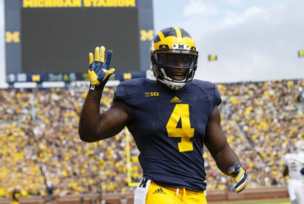 Sep 19, 2015; Ann Arbor, MI, USA; Michigan Wolverines running back De'Veon Smith (4) celebrates a touchdown in the first quarter against the UNLV Rebels at Michigan Stadium. Mandatory Credit: Rick Osentoski-USA TODAY Sports