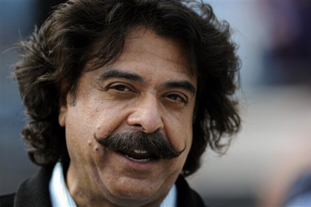 Jacksonville Jaguars owner Shad Khan talks with fans on the sidelines before the start of an NFL football game against the New England Patriots, Sunday, Dec. 23, 2012, in Jacksonville, Fla. (AP Photo/Stephen Morton)