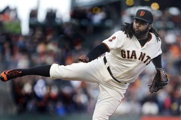 FILE - In this July 6, 2016, file photo, San Francisco Giants pitcher Johnny Cueto works against the Colorado Rockies in the first inning of a baseball game in San Francisco. Texas' Ian Desmond wasn’t the biggest name on the free agent market. But his big first half has helped the Rangers take a commanding lead in the AL West, and he’s been one of the most successful new acquisitions in baseball so far in 2016. Daniel Murphy and Johnny Cueto have also paid immediate dividends for their new teams. (AP Photo/Ben Margot, File)