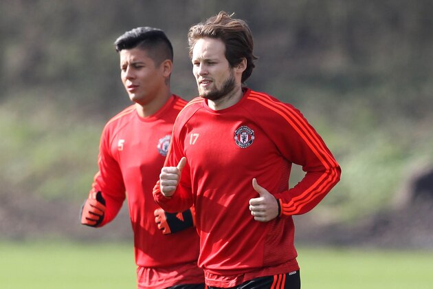 Manchester United's Argentinian defender Marcos Rojo and Manchester United's Dutch midfielder Daley Blind (R) take part in a team training session at their Carrington Training Centre in Manchester, north west England on February 24, 2016.
The gloom that has been descending on Manchester United lifted a little when they beat Shrewsbury in the FA Cup on Monday, but manager Louis van Gaal remains a man facing problems. United's manager has no margin for error as he attempts to maintain his team's chances of a European trophy when they face Midtjylland at Old Trafford on Thursday.
 / AFP / LINDSEY PARNABY        (Photo credit should read LINDSEY PARNABY/AFP/Getty Images)
