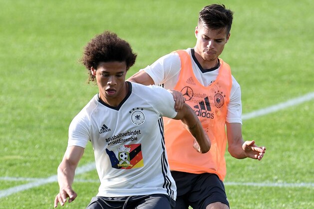 Germany's defender Julian Weigl (R) vies with Germany's midfielder Leroy Sane during a training session at Germany's training grounds in Evian-les-Bains, central-eastern France, on June 7, 2016, three days ahead of the Euro 2016 football tournament. / AFP / PATRIK STOLLARZ        (Photo credit should read PATRIK STOLLARZ/AFP/Getty Images)