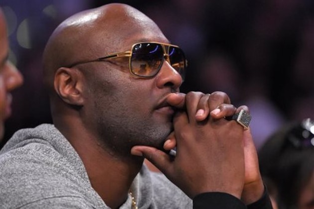 Former Los Angeles Lakers' Lamar Odom watches during the second half of an NBA basketball game between the Lakers and the Miami Heat, Wednesday, March 30, 2016, in Los Angeles. The Lakers won 102-100 in overtime. (AP Photo/Mark J. Terrill)
