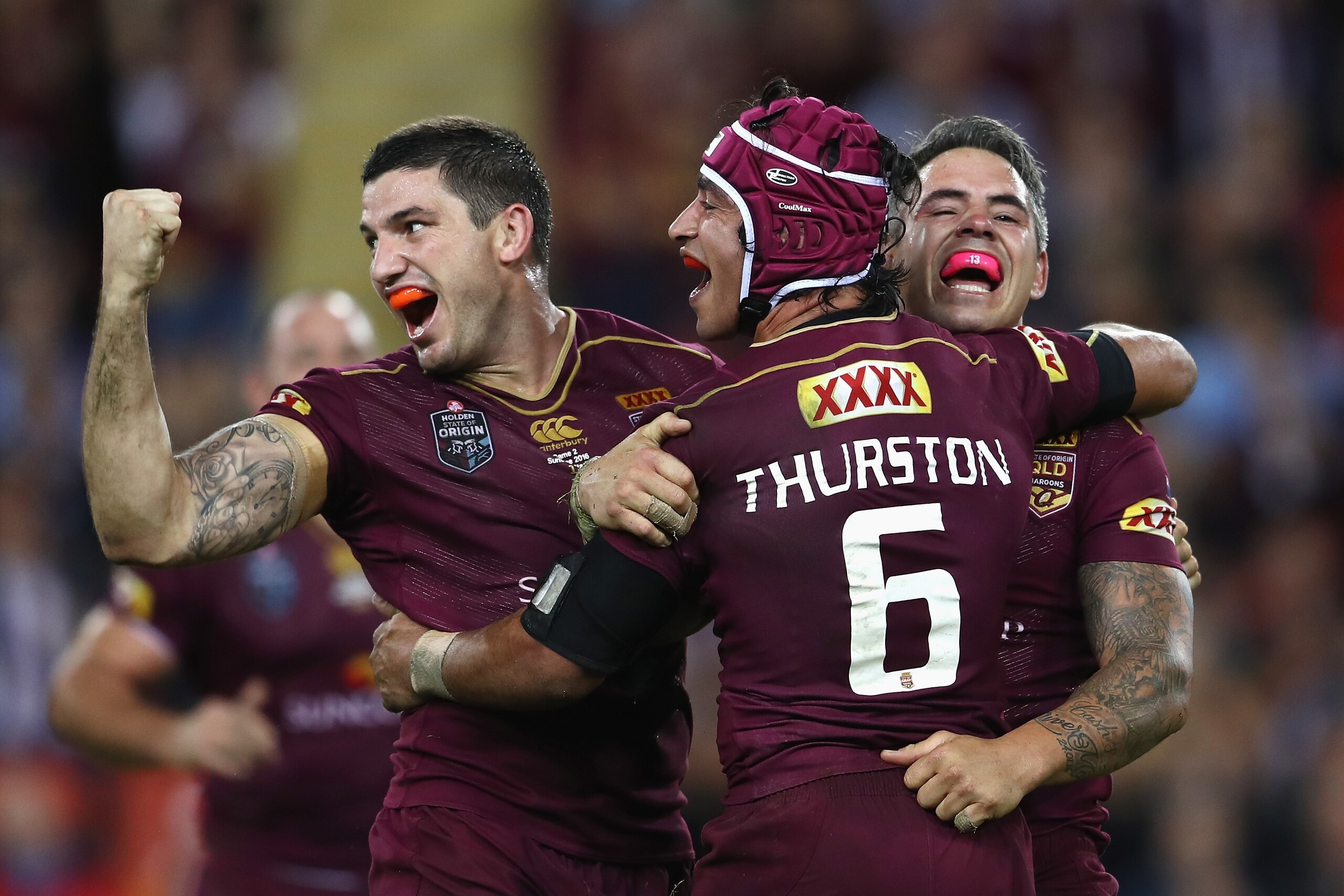 BRISBANE, AUSTRALIA - JUNE 22:  Matt Gillett, Johnathan Thurston and Corey Parker of the Maroons celebrate victory during game two of the State Of Origin series between the Queensland Maroons and the New South Wales Blues at Suncorp Stadium on June 22, 2016 in Brisbane, Australia.  (Photo by Mark Kolbe/Getty Images)