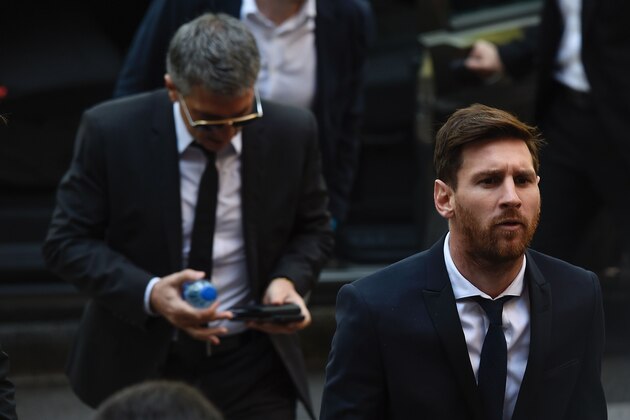 Barcelona's football star Lionel Messi (R) followed by his father Jorge Horacio Messi arrives at the courthouse on June 2, 2016 in Barcelona, where Messi and his father are to face judges in a tax fraud case.
The 28-year-old football star was cheered and jeered as he emerged from a van accompanied by his father Jorge Horacio Messi. The two are accused of using a chain of fake companies in Belize and Uruguay to avoid paying taxes on 4.16 million euros ($4.6 million) of Messi's income earned through the sale of his image rights from 2007-09. / AFP / JOSEP LAGO        (Photo credit should read JOSEP LAGO/AFP/Getty Images)