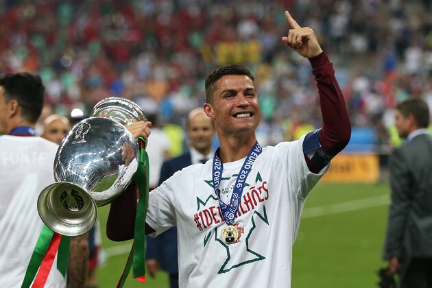 PARIS, FRANCE - JULY 10: Cristiano Ronaldo of Portugal celebrates with the trophy following the UEFA Euro 2016 Final match between Portugal and France at Stade de France on July 10, 2016 in Paris, France. (Photo by Chris Brunskill Ltd/Getty Images)