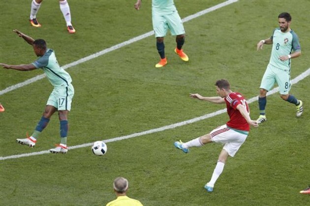 Hungary's Zoltan Gera, second from right,  scores his side's first goal during the Euro 2016 Group F soccer match between Hungary and Portugal at the Grand Stade in Decines-Charpieu, near Lyon, France, Wednesday, June 22, 2016. (AP Photo/Michael Sohn)
