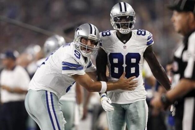 FILE - In this Sept. 13, 2015, file photo, Dallas Cowboys quarterback Tony Romo (9) and wide receiver Dez Bryant (88) react during the first half of an NFL football game against the New York Giants in Arlington, Texas. Both are anxious to get on the field together after injuries kept them apart most of last season, when Dallas slid from first to worst in the NFC East. (AP Photo/Brandon Wade, File)