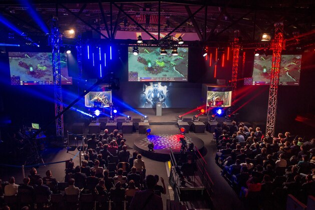 Spectators watch as gamers compete on April 4, 2015 in a round of the world tournament of the game StarCraft II, during the 16th edition of the Gamers Assembly 2015 (GA 2015) in the 15,000 square meters exhibition center of Poitiers, with 2,000 players and 19 official competitions taking place, including an international round of the game StarCraft II. AFP PHOTO / GUILLAUME SOUVANT        (Photo credit should read GUILLAUME SOUVANT/AFP/Getty Images)