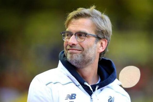 FILE- In this Thursday, May 5, 2016 file photo, Liverpool's manager Juergen Klopp smiles before the Europa League semifinal, second leg, soccer match between Liverpool and Villarreal at Anfield Stadium, Liverpool, England. Liverpool says coach Klopp has signed a new