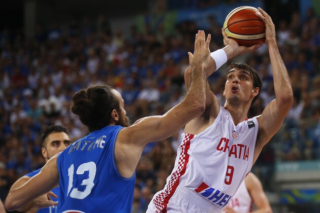 Italy's small forward Luigi Datome defends against to Croatia's forward Dario Saric during the final match of the Olympic Qualifying Tournament Croatia vs Italy at PalaIsozaki in Turin on July 9, 2016.  / AFP / MARCO BERTORELLO        (Photo credit should read MARCO BERTORELLO/AFP/Getty Images)