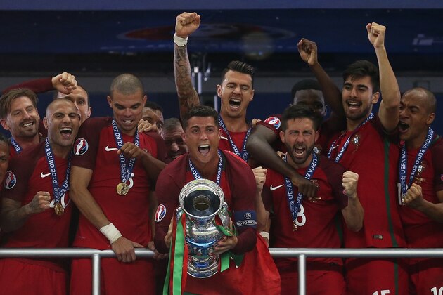 PARIS, FRANCE - JULY 10: Cristiano Ronaldo of Portugal lifts the trophy following the UEFA Euro 2016 Final match between Portugal and France at Stade de France on July 10, 2016 in Paris, France. (Photo by Chris Brunskill Ltd/Getty Images)