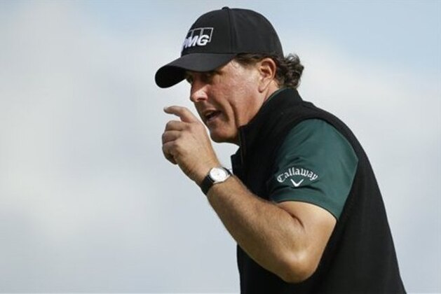 Phil Mickelson of the United States acknowledges the crowd after putting on the 13th green during the first round of the British Open Golf Championship at the Royal Troon Golf Club in Troon, Scotland, Thursday, July 14, 2016. (AP Photo/Matt Dunham)
