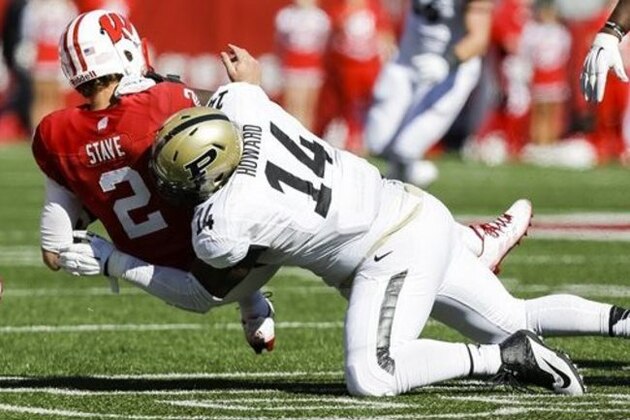 Purdue defensive tackle Ra'Zahn Howard (14) sacks Wisconsin quarterback Joel Stave (2) during the first half of an NCAA college football game Saturday, Oct. 17, 2015, in Madison, Wis. (AP Photo/Andy Manis)