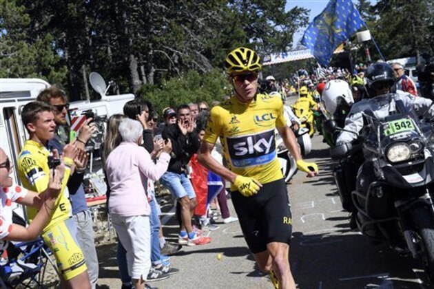 Britain's Chris Froome, wearing the overall leader's yellow jersey runs after he crashed at the end of the twelfth stage of the Tour de France cycling race with start in Montpellier and finish six kilometers (3.7 miles) before the Mont Ventoux, France, Thursday, July 14, 2016. The wind, combined with a temperature just above the freezing level on top of the