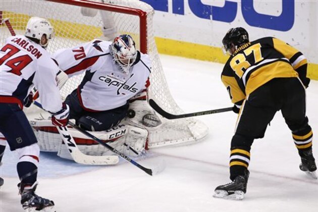 Washington Capitals goalie Braden Holtby stops a shot by Pittsburgh Penguins' Sidney Crosby (87) during Game 6 of the NHL hockey Stanley Cup Eastern Conference semifinals, against the Pittsburgh Penguins, Tuesday, May 10, 2016 in Pittsburgh. (AP Photo/Gene J. Puskar)