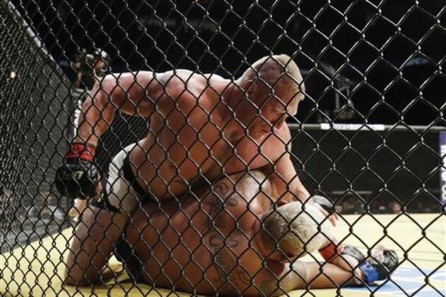 Brock Lesnar, top, fights Mark Hunt during their heavyweight mixed martial arts bout at UFC 200, Saturday, July 9, 2016, in Las Vegas. (AP Photo/John Locher)