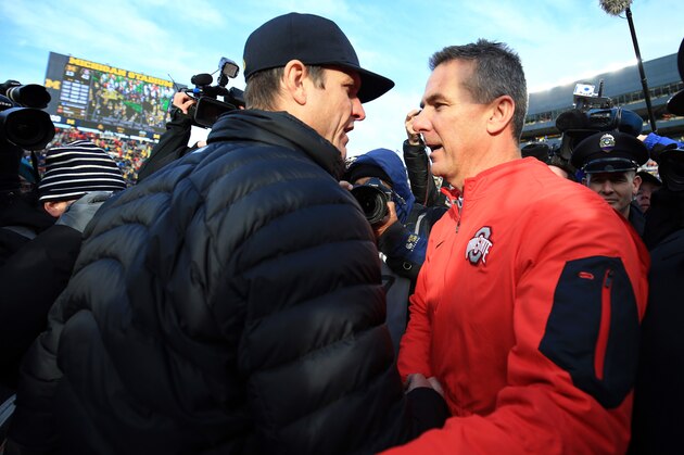 ANN ARBOR, MI - NOVEMBER 28: Head coach Urban Meyer of the Ohio State Buckeyes and head coach Jim Harbaugh of the Michigan Wolverines after the game against the Michigan Wolverines at Michigan Stadium on November 28, 2015 in Ann Arbor, Michigan. Ohio State defeated Michigan 42-13. (Photo by Andrew Weber/Getty Images)