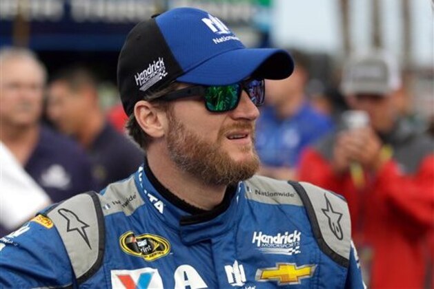 Dale Earnhardt Jr. waits by his car before the start of the NASCAR Sprint Cup Series auto race at Daytona International Speedway, Saturday, July 2, 2016, in Daytona Beach, Fla. (AP Photo/John Raoux)