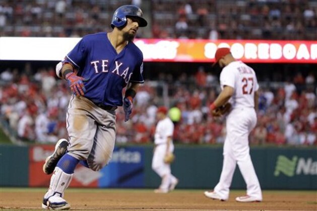 Texas Rangers' Rougned Odor, left, rounds the bases past St. Louis Cardinals third baseman Jhonny Peralta after hitting a solo home run during the fifth inning of a baseball game Friday, June 17, 2016, in St. Louis. (AP Photo/Jeff Roberson)