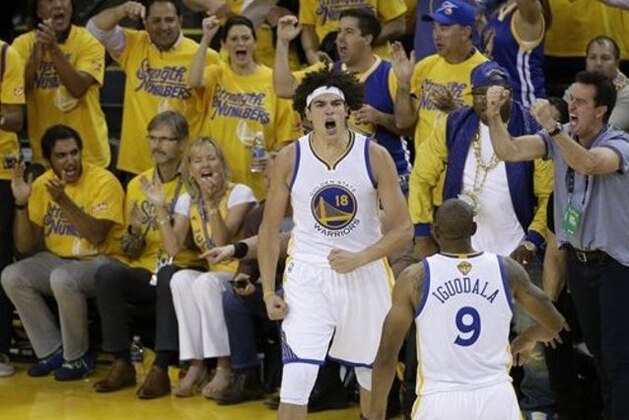 Golden State Warriors forward Anderson Varejao (18) and forward Andre Iguodala (9) react during the second half of Game 5 of basketball's NBA Finals against the Cleveland Cavaliers in Oakland, Calif., Monday, June 13, 2016. (AP Photo/Marcio Jose Sanchez)