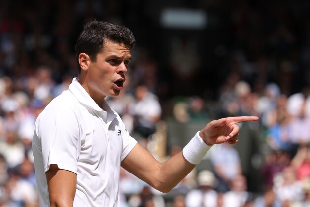 Canada's Milos Raonic reacts while playing Britain's Andy Murray during the men's singles final match on the last day of the 2016 Wimbledon Championships at The All England Lawn Tennis Club in Wimbledon, southwest London, on July 10, 2016. / AFP / POOL AND AFP / John WALTON / RESTRICTED TO EDITORIAL USE        (Photo credit should read JOHN WALTON/AFP/Getty Images)