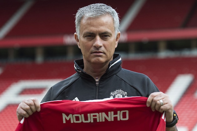 Manchester United's new Portuguese manager Jose Mourinho poses with a football shirt on the pitch at Old Trafford stadium in Manchester, northern England, on July 5, 2016.
Jose Mourinho officially started work as Manchester United manager at the club's Carrington training base yesterday. The 53-year-old was appointed as United boss in May after the sacking of Dutchman Louis van Gaal. / AFP / OLI SCARFF        (Photo credit should read OLI SCARFF/AFP/Getty Images)