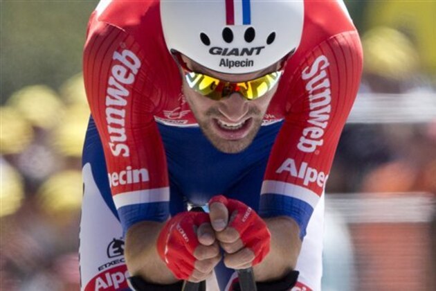 Netherlands’ Tom Dumoulin crosses the finish line during the thirteenth stage of the Tour de France cycling race, an individual time trial over 37.5 kilometers (23 miles) with start in Bourg-Saint-Andeol and finish in La Caverne du Pont-d'Arc, France, Friday, July 15, 2016. (AP Photo/Peter Dejong)