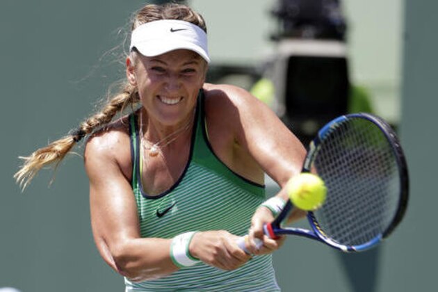 Victoria Azarenka, of Belarus, returns to Svetlana Kuznetsova during the women's singles final match at the Miami Open tennis tournament, Saturday, April 2, 2016, in Key Biscayne, Fla. Azarenka won 6-3, 6-2. (AP Photo/Lynne Sladky)