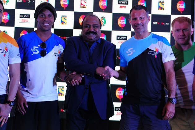 Former Brazilian footballer Ronaldhino (2L) poses with other players including former Welsh international player Ryan Giggs (2nd R) during a media briefing for the Premier Futsal Football League in Chennai on July 14, 2016. / AFP / ARUN SANKAR        (Photo credit should read ARUN SANKAR/AFP/Getty Images)