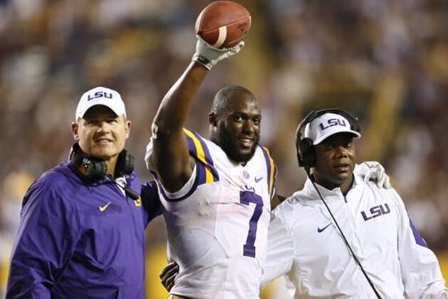 LSU Tigers head coach Les Miles hands  running back Leonard Fournette a game ball after breaking the single season rushing record during the second half of an NCAA college football game against Texas A&M in Baton Rouge, La., Saturday, Nov. 28, 2015. (AP Photo/Jonathan Bachman)
