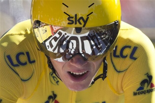 Britain's Chris Froome, wearing the overall leader's yellow jersey, crosses the finish line of the thirteenth stage of the Tour de France cycling race, an individual time trial over 37.5 kilometers (23 miles) with start in Bourg-Saint-Andeol and finish in La Caverne du Pont-d'Arc, France, Friday, July 15, 2016. (AP Photo/Peter Dejong)