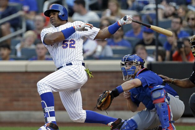 Jul 2, 2016; New York City, NY, USA; New York Mets center fielder Yoenis Cespedes (52) follows through on a double in front of Chicago Cubs catcher Miguel Montero (47) during the first inning at Citi Field. Mandatory Credit: Adam Hunger-USA TODAY Sports