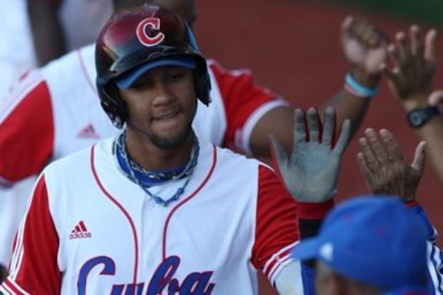Cuba's Yulieski Gurriel is congratulated by teammates after his two-run home run during the fourth inning of the bronze baseball match against Mexico at the Pan American Games in Lagos de Moreno, Mexico, Tuesday, Oct. 25, 2011.(AP Photo/Javier Galeano)