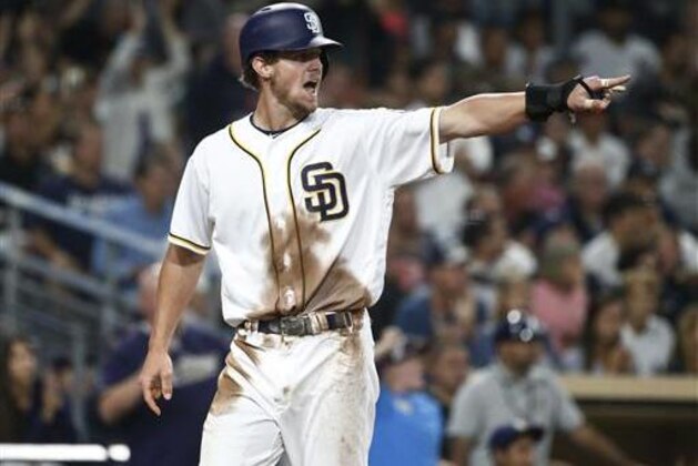 San Diego Padres' Wil Myers points to teammate Matt Kemp after scoring on a double by Kemp against the New York Yankees during the sixth inning of a baseball game Saturday, July 2, 2016, in San Diego. (AP Photo/Lenny Ignelzi)