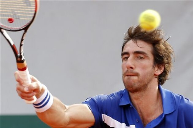 Uruguay's Pablo Cuevas returns in the third round match of the French Open tennis tournament against Tomas Berdych of the Czech Republic at the Roland Garros stadium in Paris, France, Saturday, May 28, 2016. (AP Photo/Michel Euler)
