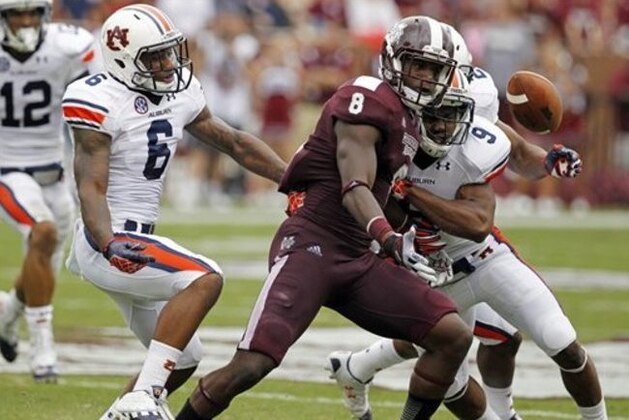 Mississippi State wide receiver Chris Smith (8) fumbles a pass reception as Auburn defensive backs Jermaine Whitehead (9) and Jonathon Mincy (6) rush in to cover in the first quarter of their NCAA college football game in Starkville, Miss., Saturday, Sept. 8, 2012.  Auburn recovered the fumble. (AP Photo/Rogelio V. Solis)
